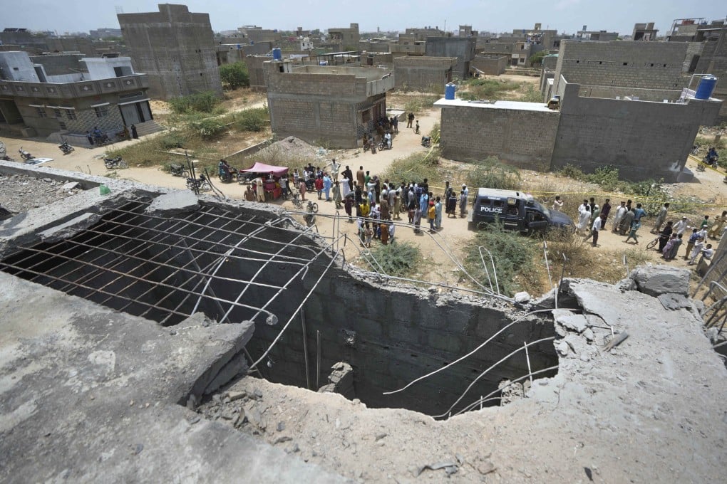 A house bears a gaping hole in its rooftop in Pakistan’s financial capital and largest city Karachi on Thursday, suspected to have been damaged in an Indian drone attack. Photo: AP