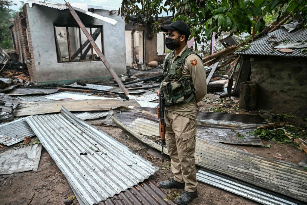 A soldier stands next to a house destroyed by Pakistani shelling at a village in Uri, India-administered Kashmir, on May 8. Photo: AFP