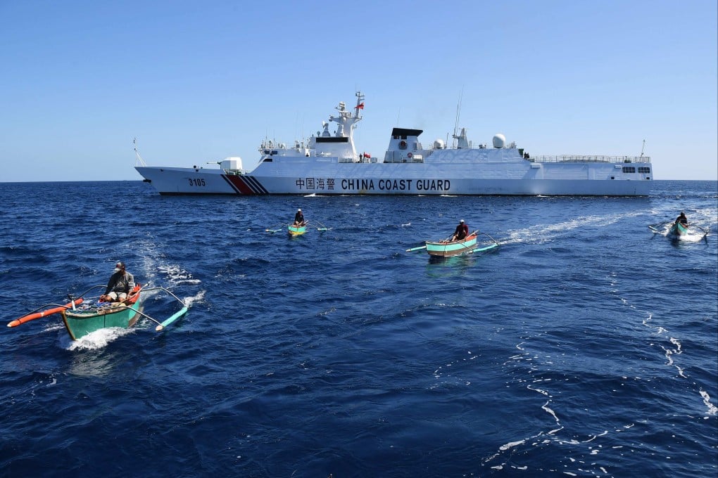 Filipino fishermen aboard their wooden boats pass a Chinese coastguard ship near the China-controlled Scarborough Shoal, in disputed waters of the South China Sea, in February 2024. Photo: AFP