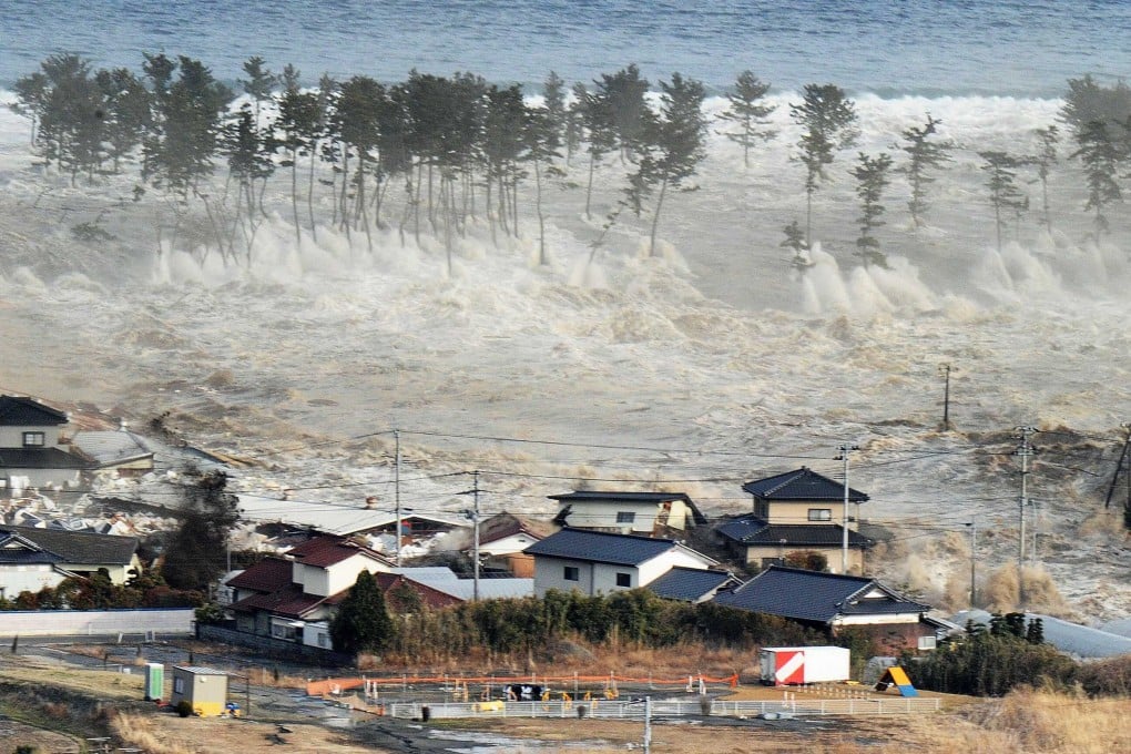 Waves of a tsunami hit residences after a powerful earthquake in Natori, Miyagi prefecture on March 11, 2011. Photo: AP