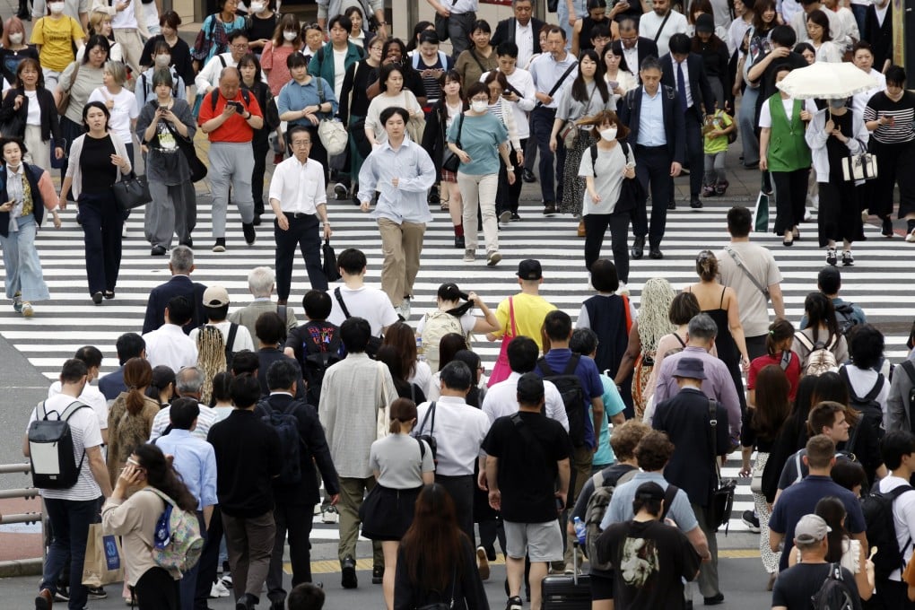 Pedestrians walk through a crossing in Tokyo. A lawmaker says Japan’s business manager visa has become an “easy route” to residency. Photo: EPA-EFE