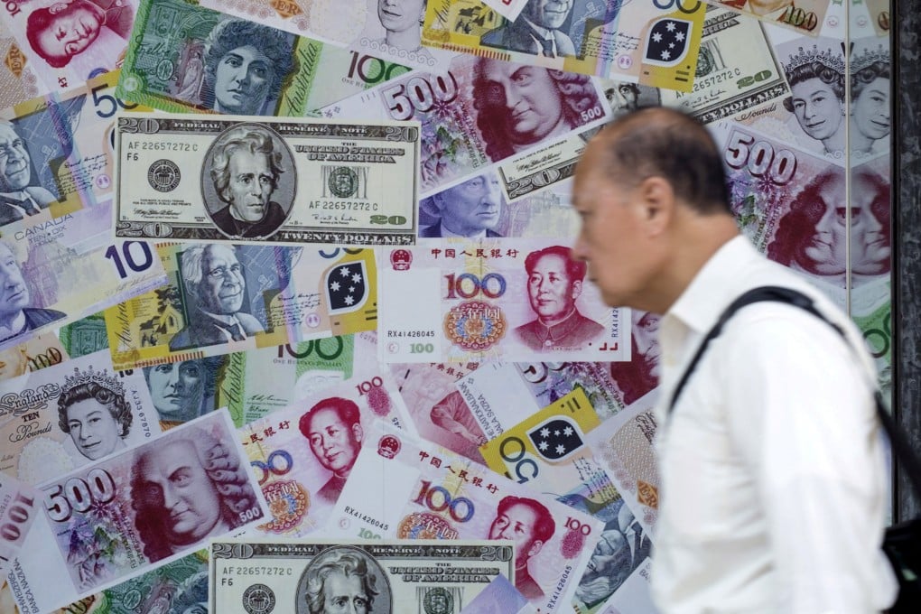 A man walks past an advertisement promoting yuan, US dollar and euro exchange services at a foreign exchange store in Hong Kong. Photo: Reuters