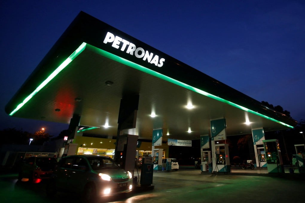 A motorist pumps petrol at a Petronas gas station in Putrajaya. Photo: Reuters