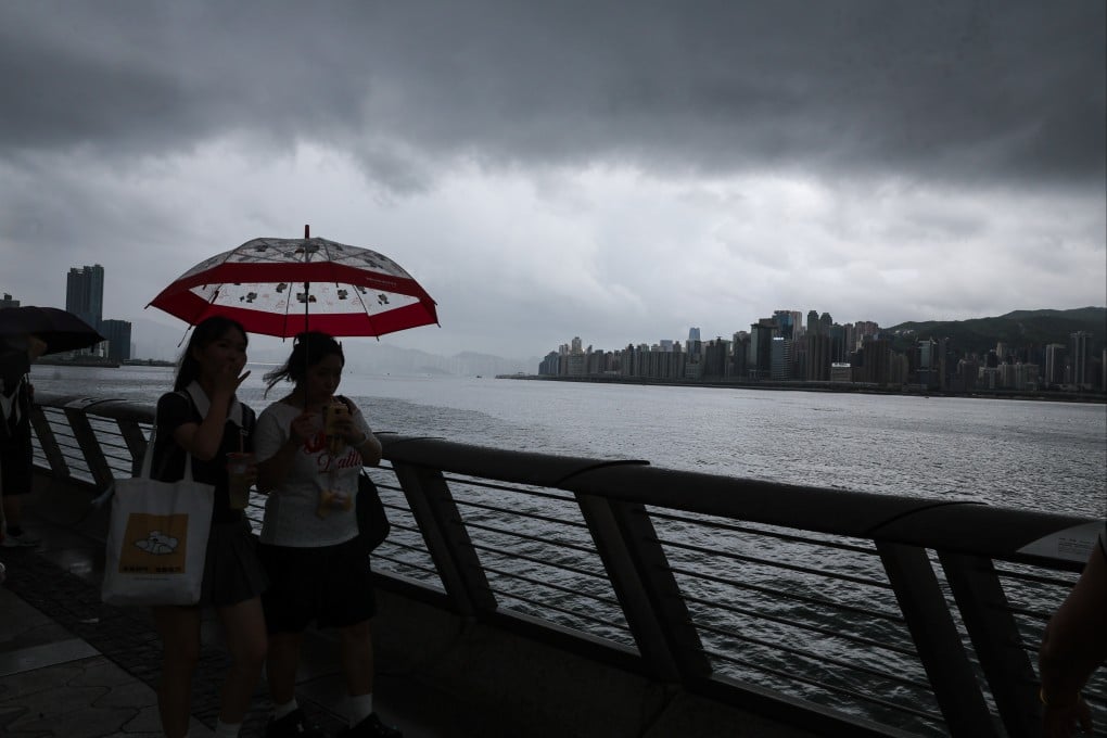 Tourists walk along the Avenue of Stars under last week’s storm clouds. Photo: Edmond So