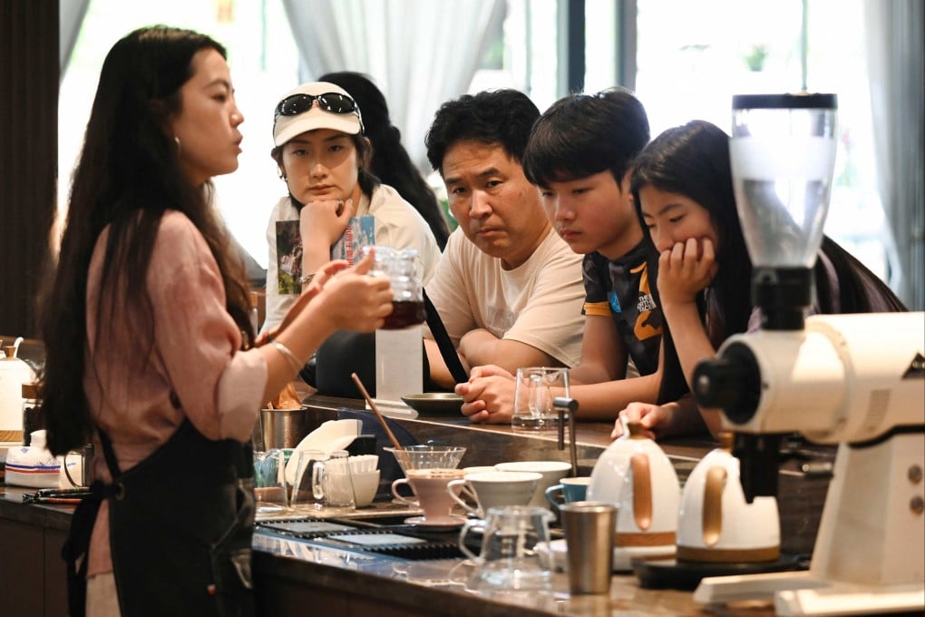 In China, a growing middle class has led to a boom in coffee sales. In the traditional tea-growing Puer area, in China’s southwest Yunnan province, a staff member pours coffee for guests at the Xiaowazi, or Little Hollow, coffee plantation. Photo: AFP