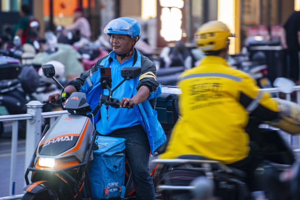 Ele.me food deliveryman and a Meituan food deliveryman ride on the street on May 14, 2025 in Yancheng, Jiangsu province of China. Photo: VCG via Getty Images