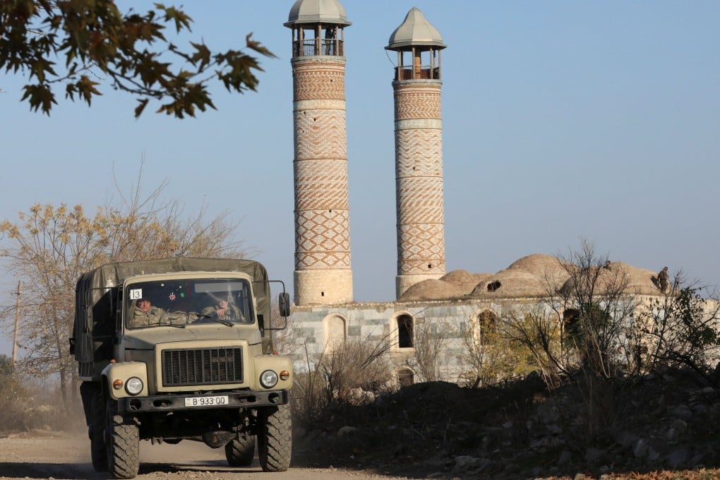 Azerbaijani military drive a truck near a mosque in Agdam in the Karabakh region in 2020. Photo: Reuters