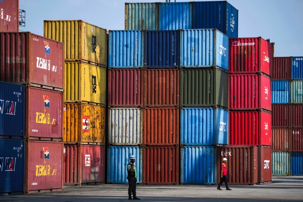 Two workers at IPC Container Terminal at Tanjung Priok Port in Jakarta, Indonesia, on August 6. Photo: AP