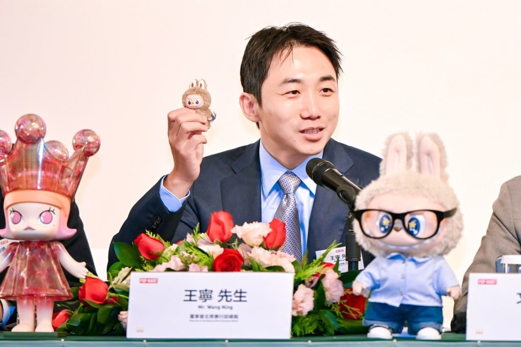 Pop Mart’s founder and CEO Wang Ning with a mini Labubu plush toy during the company’s post-earnings press conference in Hong Kong on Wednesday. Photo: Handout