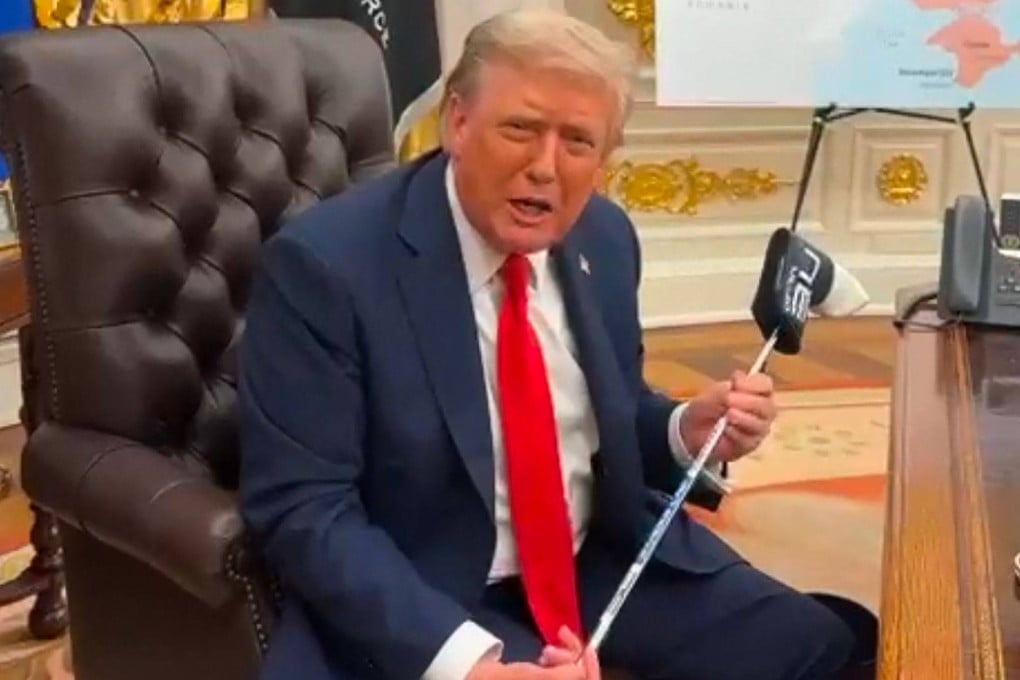 US President Donald Trump with a golf club presented to him by Ukrainian President Volodymyr Zelensky at the White House in Washington in an image grab taken from a video provided on Tuesday by the Ukrainian Presidential Office. Photo: Ukrainian Presidential Office / AFP / Handout