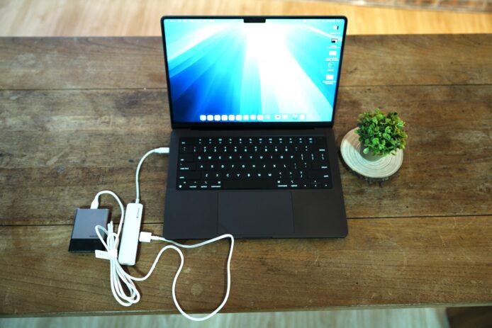 充電中的筆記本電腦,連接多個充電器和線纜.