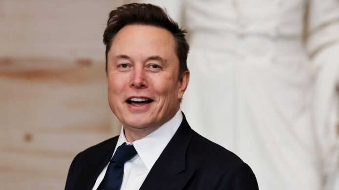 SpaceX CEO Elon Musk in formal suit at event.