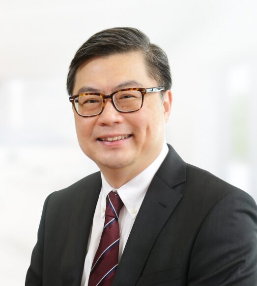 穿著西裝的男士微笑面對鏡頭.