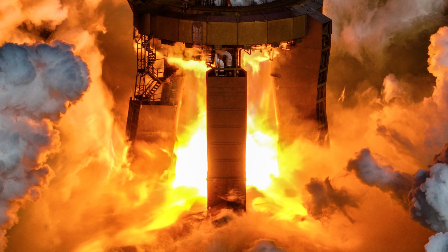 Image shows the Super Heavy booster lighting up its engines for a full duration static fire