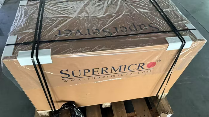 Supermicro server box wrapped in plastic on a pallet, ready for shipping.