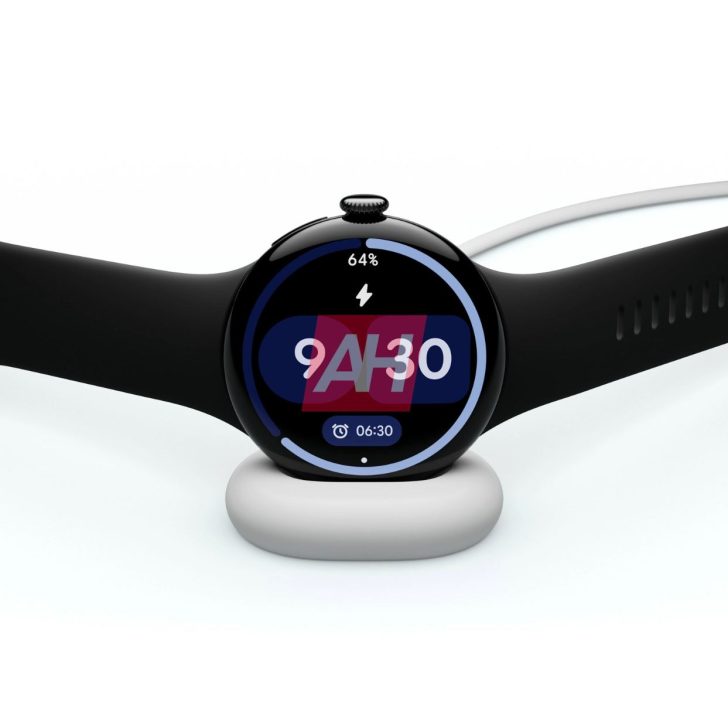 Smartwatch with black strap on charging dock displaying time and battery percentage.