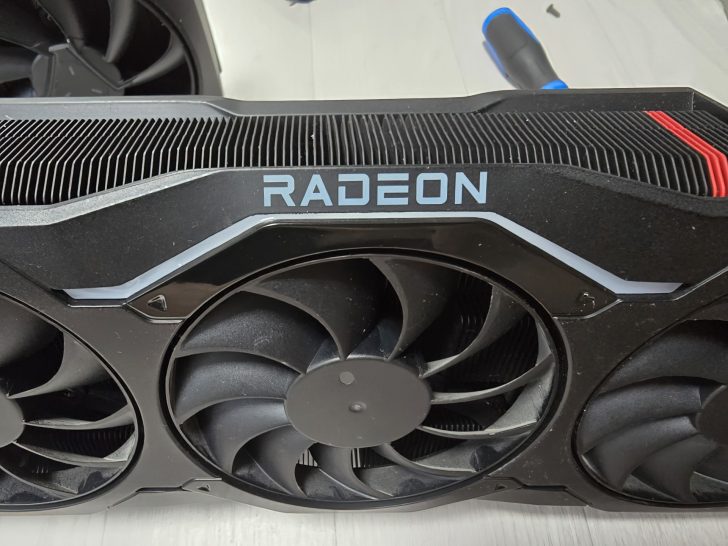 Close-up of a Radeon graphics card with cooling fans and visible branding.