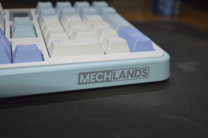 Light blue mechanical keyboard with MECHLANDS branding, featuring white and blue keycaps.