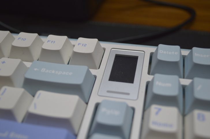 White and blue mechanical keyboard close-up with function keys.