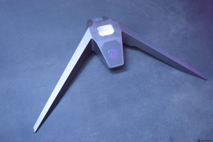 Modern RGB gaming monitor stand on dark background.