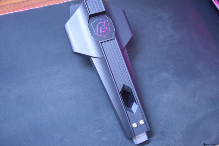 Futuristic gaming accessory on black surface with neon lighting effects and sleek design.