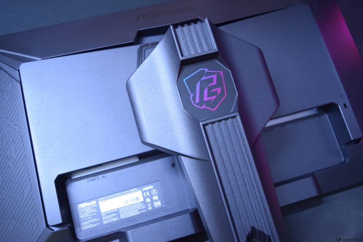 Close-up of ASRock monitor with unique design and branding, showcasing sleek, modern technology.