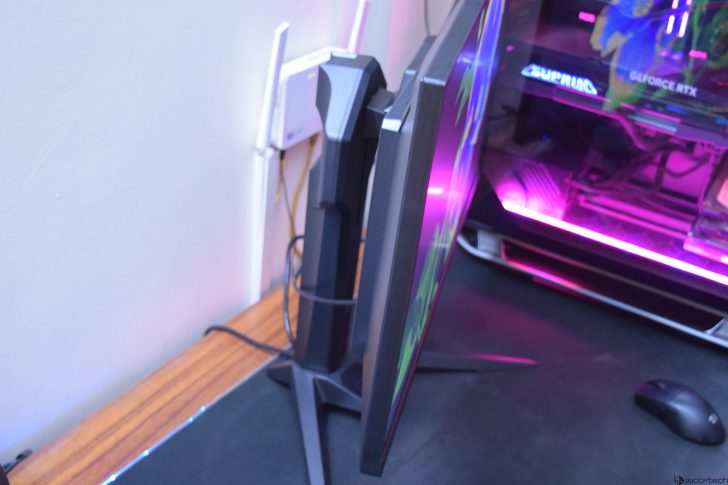 Side view of a gaming monitor and desktop with RGB lighting setup.