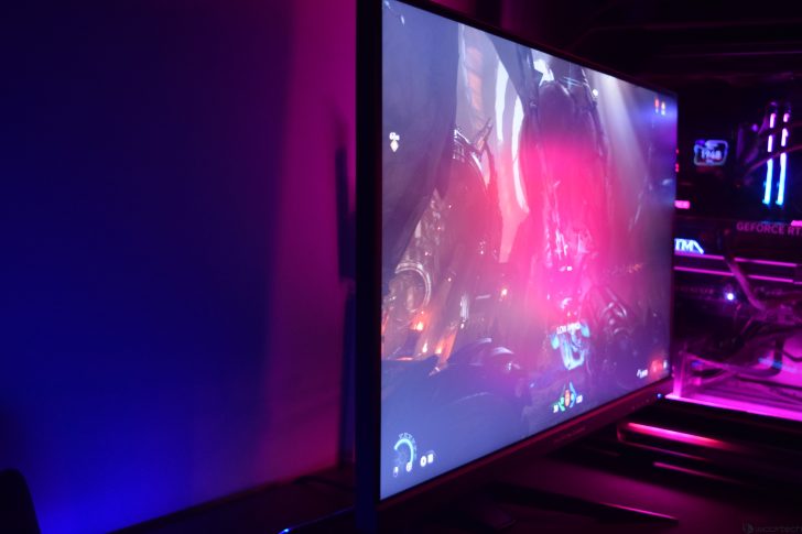 Gaming monitor with vibrant LED setup displaying sci-fi graphics.