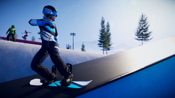 Snowboarder on a ramp, executing a trick in a snowy terrain park with clear blue skies.