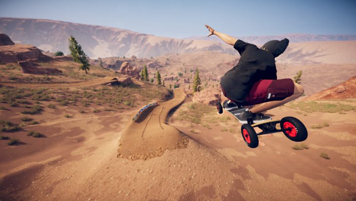 Descenders Next Mountainboarder performing jump in desert landscape, showcasing extreme sports adventure.
