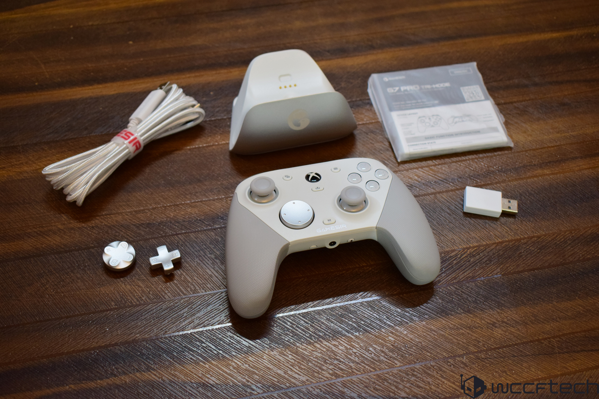Gaming controller set with accessories on a wooden surface.
