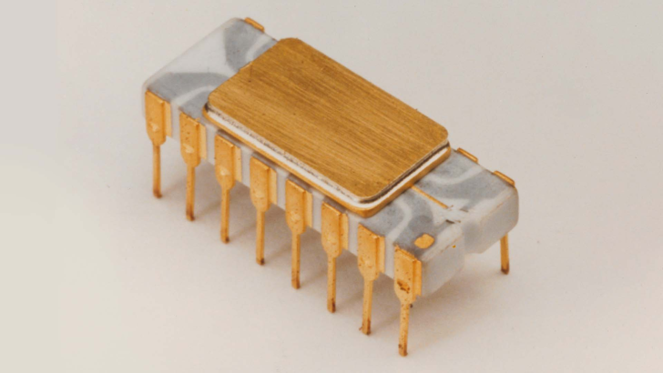 Vintage microprocessor with gold connectors, side view.