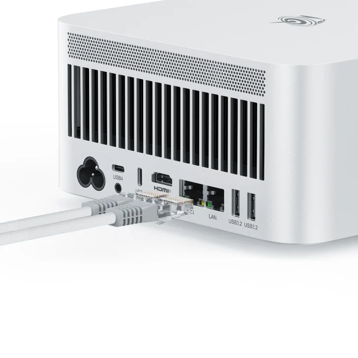 Back view of a computer with USB, HDMI, and LAN ports, showing connected cables.