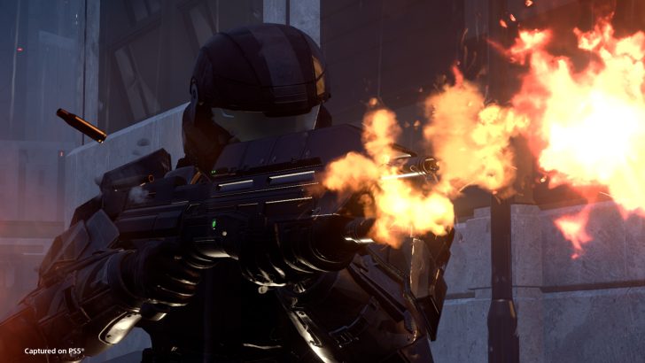 Futuristic soldier firing weapon in intense action scene, flames visible, captured on PS5.