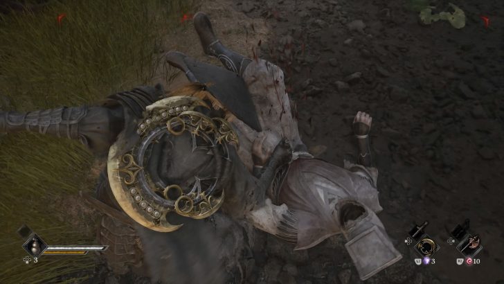 Character in ornate armor defeating an opponent on the ground, game interface displaying “L2 3” and “R2 10” in the corner.