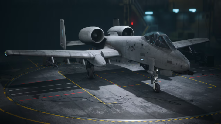A-10 Thunderbolt II aircraft on display in a dimly lit hangar, highlighting its unique design.