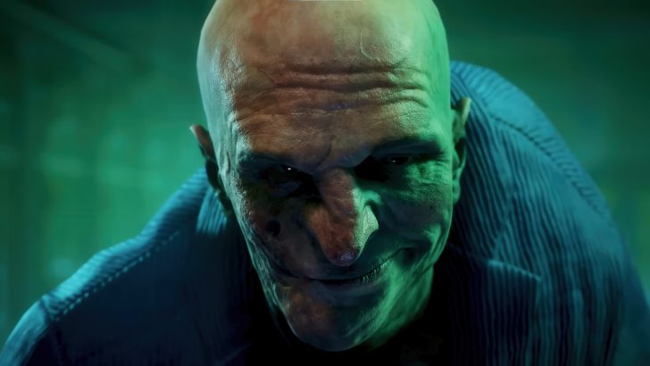 Animated character with a scarred face and green lighting looks forward, wearing a blue striped garment.