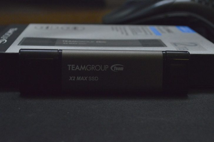 TEAMGROUP X2 MAX SSD on a table, with packaging in the background.