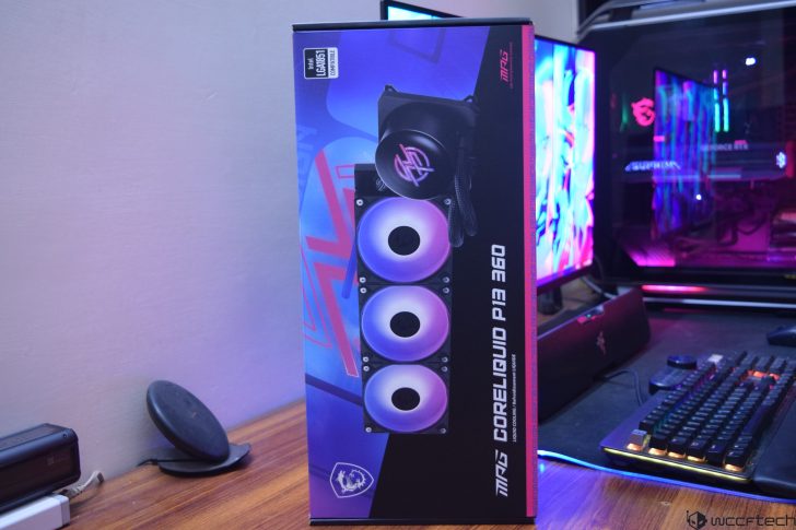 Box of MPG Coreliquid P13 360 cooler on a desk near a gaming setup.