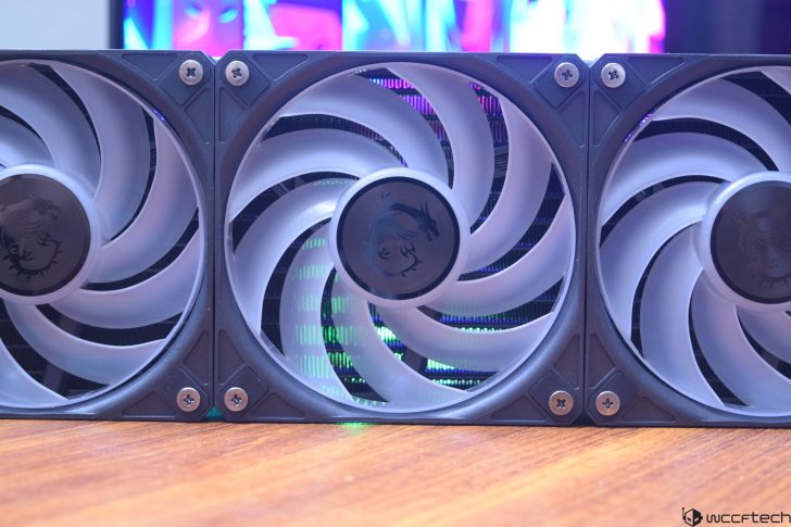 Triple fan GPU setup with gaming RGB lighting in a computer build.