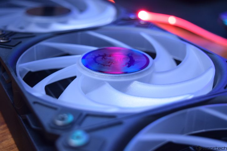 Close-up of illuminated computer fan with RGB lighting effects.