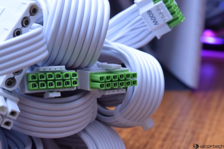 Organized white and green computer cables for efficient power supply setup.