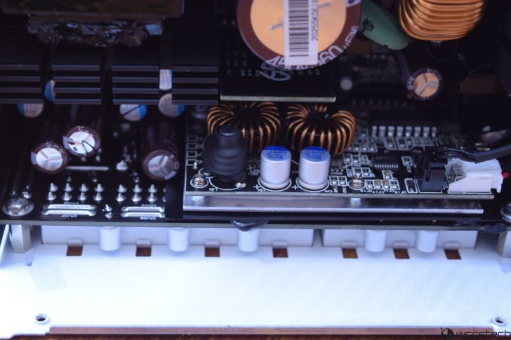 Close-up of electronic circuit board with capacitors and coils.