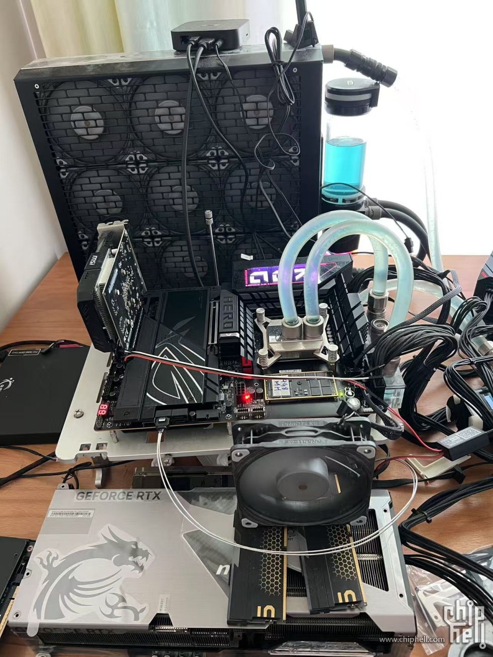 Custom water-cooled PC setup with RGB lighting and GeForce RTX graphics card on a test bench.