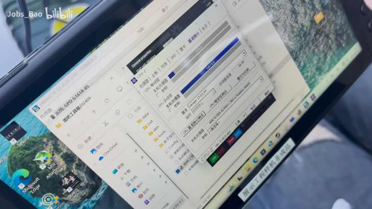 Tablet displaying CPU-Z system info and folders on desktop.