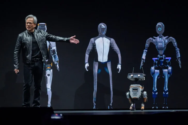 Presenter showcases futuristic robots on stage.