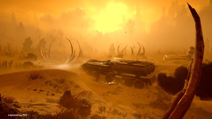 Futuristic vehicle traversing an alien desert landscape at sunset, with skeletal remains.