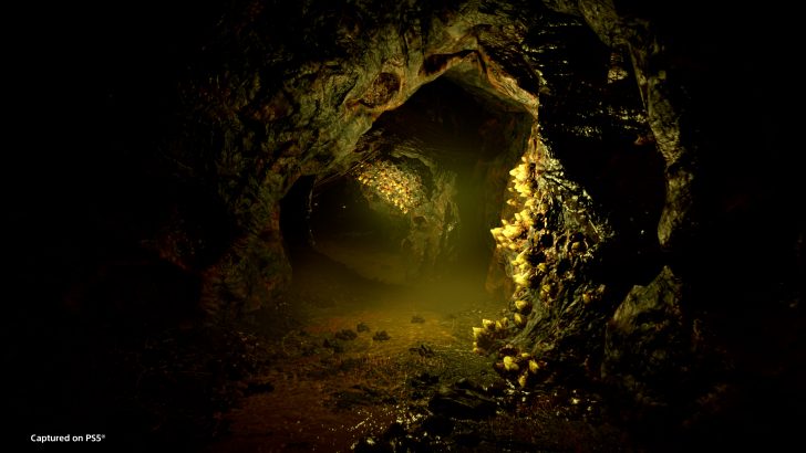 Dark rocky cave with glowing crystals, illuminated path, mysterious and atmospheric scene.