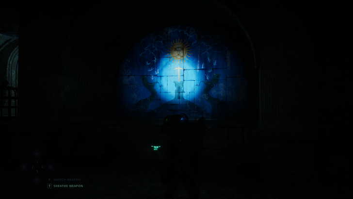 A mural with a sun and two snakes in a dark room displays options switch weapon and sheathe weapon at the bottom.