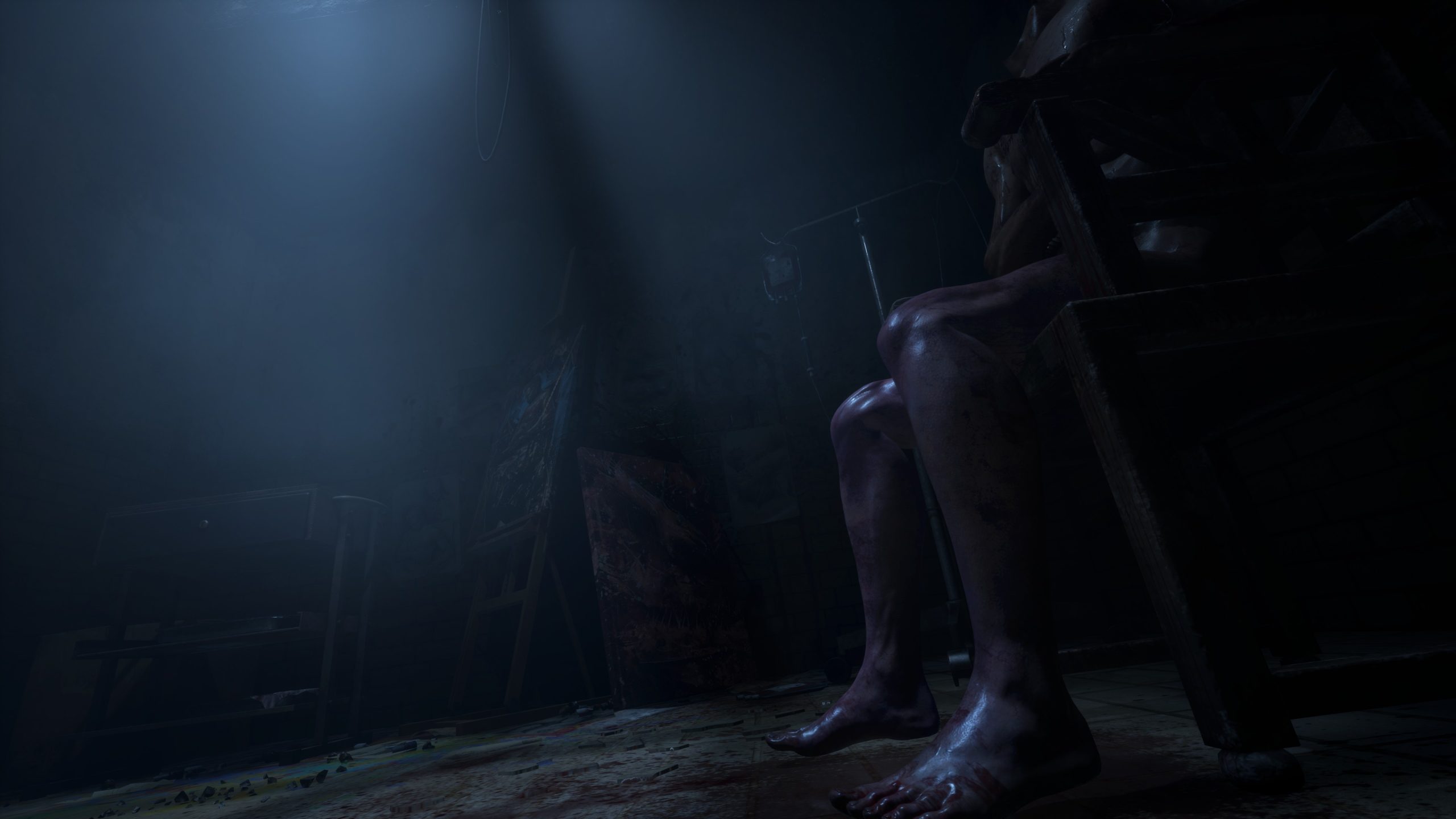 Dark room with dim lighting, shadowed figure on chair, creating a mysterious atmosphere.